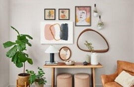 Girl walking away from a wall filled with posters and artworks