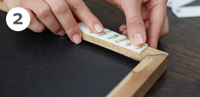 Command Picture Hanging Strips on the back of a picture frame
